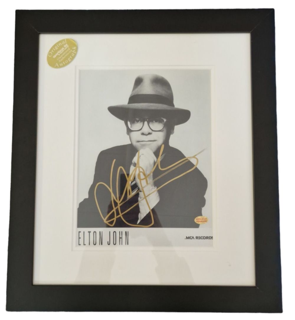 Lot 197: Elton John signed black and white photo. Mounted...