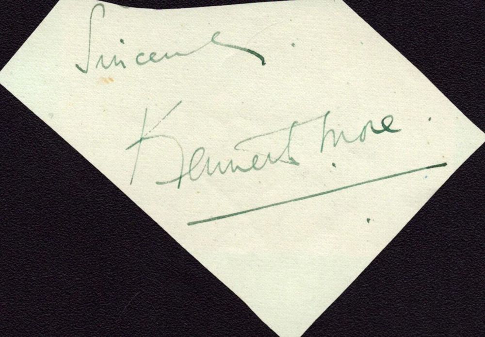 Lot 136: Kenneth More signed irregular cut signature piece. Good...