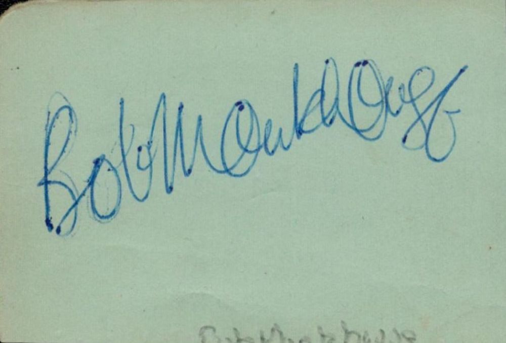 Lot 399: Bob Monkhouse small signature piece. Approx size 2x1inch....
