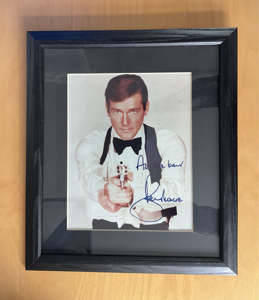 Lot 80: Roger Moore signed 15x13 inch overall framed and...