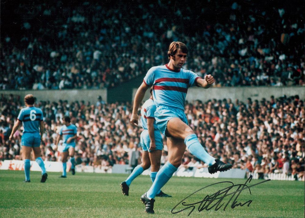 Lot 215: Geoff Hurst signed 16x12 inch colour print playing...
