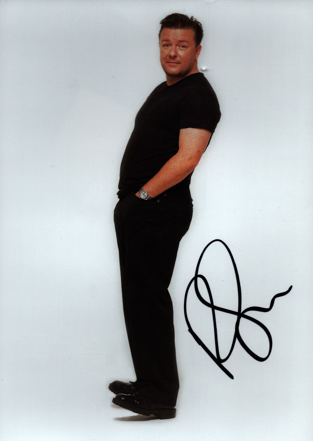 Lot 577: Ricky Gervais signed 7x5inch colour photo. Good condition....