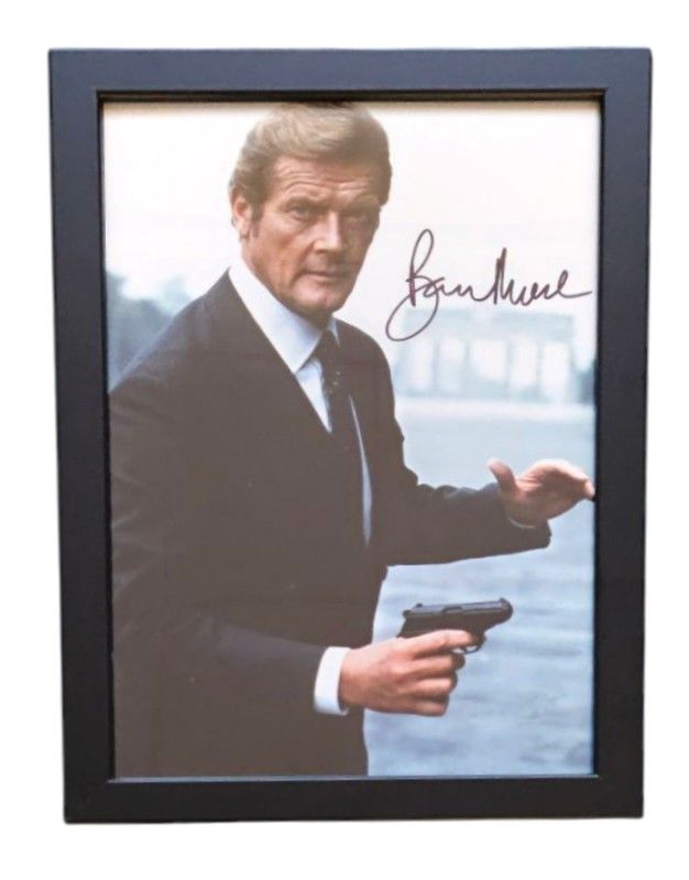 Lot 201: Roger Moore signed 13x10inch overall framed James Bond...