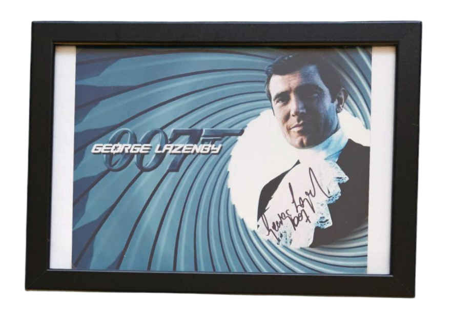 Lot 202: George Lazenby signed 13x10inch overall mounted and framed...
