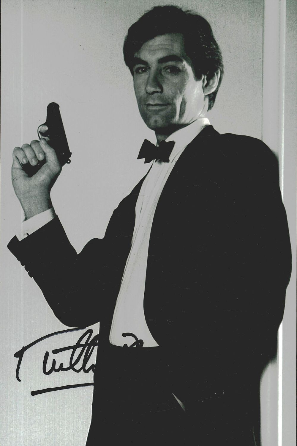 Lot 203: Timothy Dalton signed 12x8inch James Bond black and...