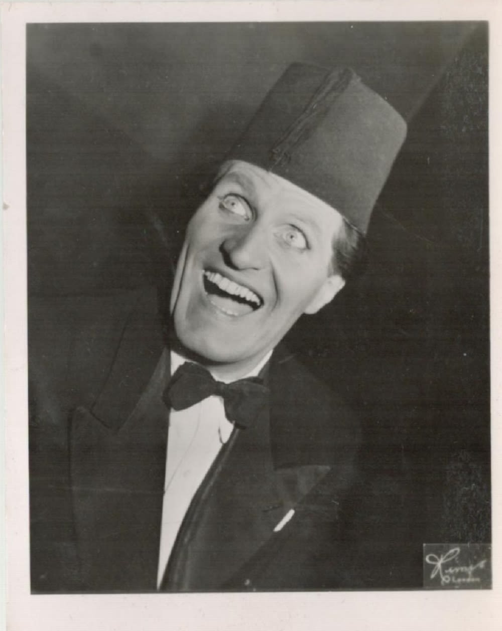 Lot 459: Tommy Cooper signed 3x3 black and white photo....