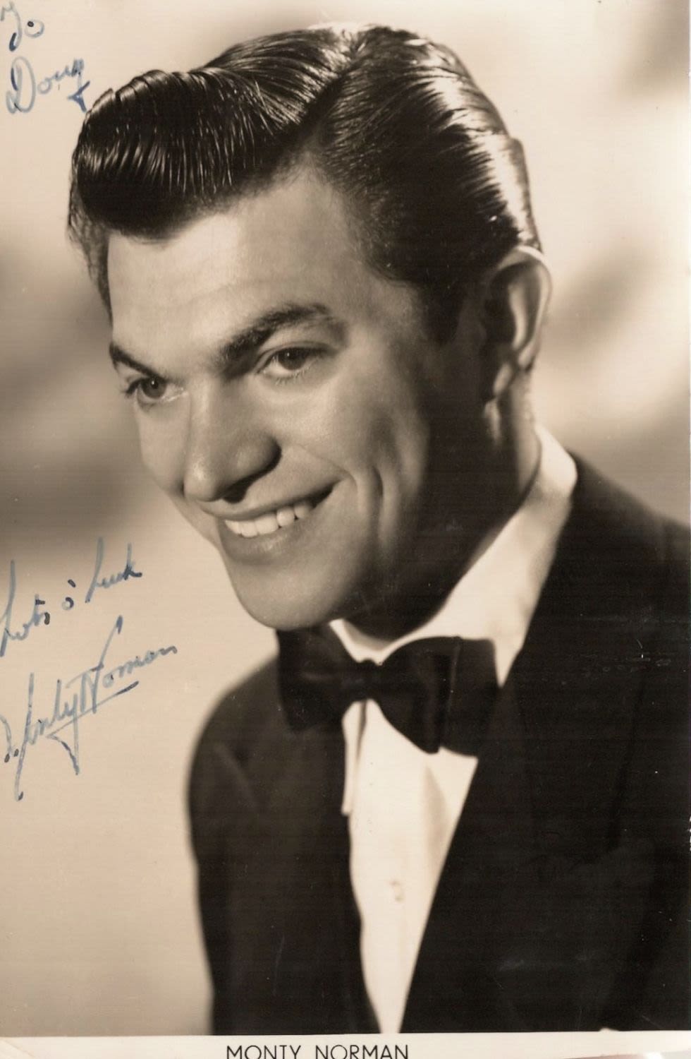 Lot 492: Monty Norman signed 6x4 black and white photo....