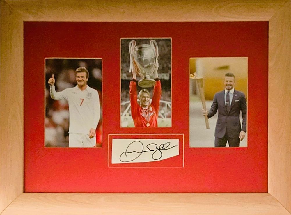 Lot 428: David Beckham irregular cut signature piece. Mounted and...