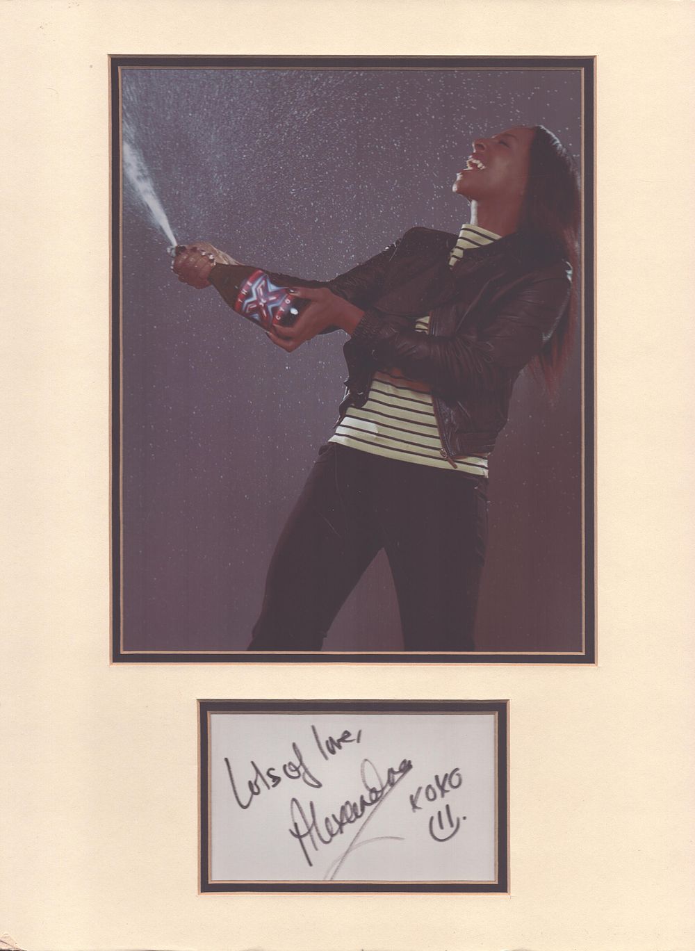 Lot 153: Alexandra Burke signature piece mounted below colour photo....