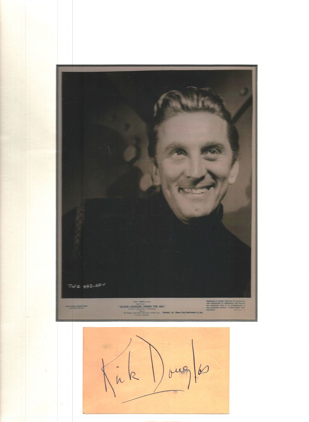Lot 204: Kirk Douglas signed album page mounted below black...
