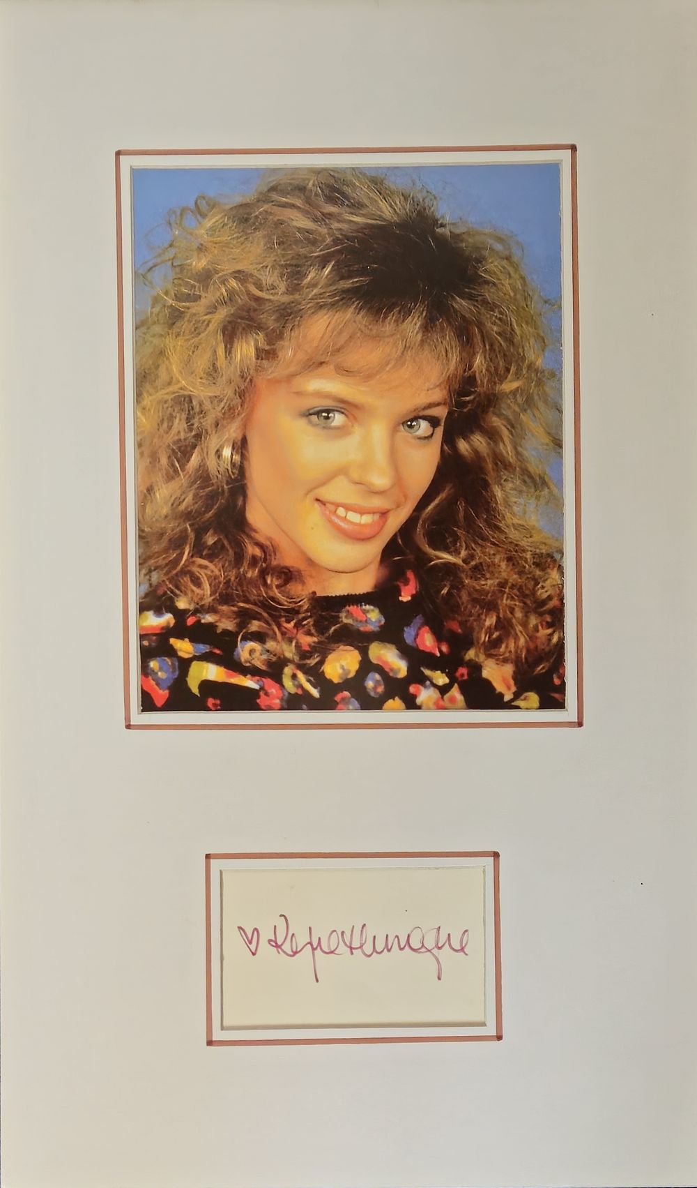 Lot 237: Kylie Minogue signature piece mounted below young colour...