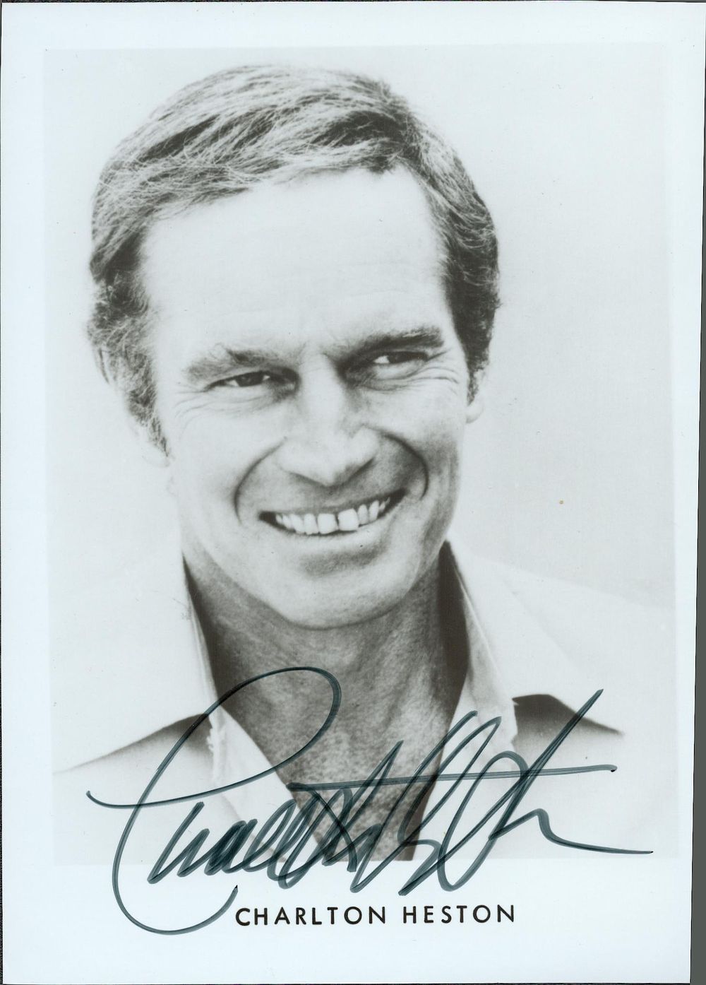 Lot 208: Charlton Heston signed 7x5inch black and white photo....