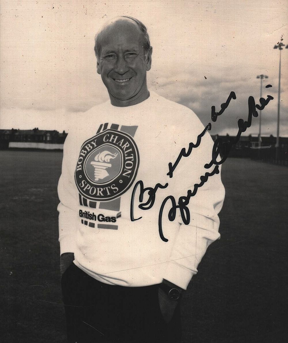 Lot 504: Sir Bobby Charlton, CBE signed 5x4 inch black...