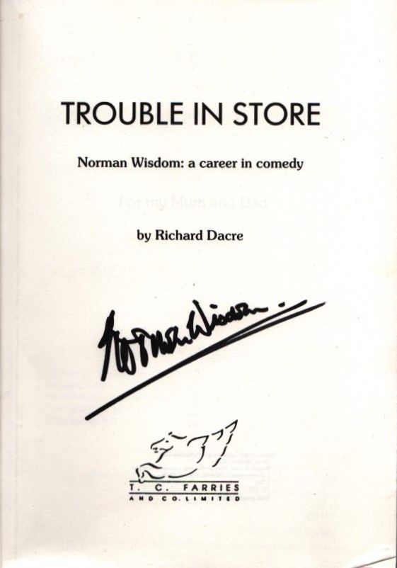 Lot 282: Norman Wisdom signed paperback book titled Trouble in...