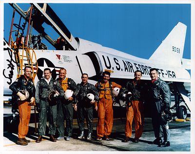 Aurora 7 Astronaut Scott Carpenter signed 10x8 inch colour photo standing by the jet with other 
