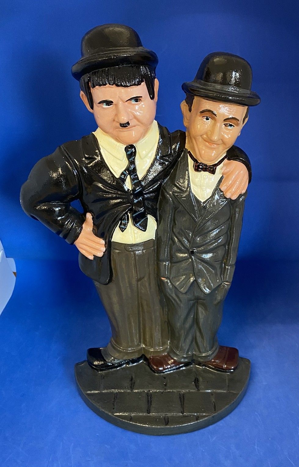 Lot 304: Laurel and Hardy cast iron door stop, stands...