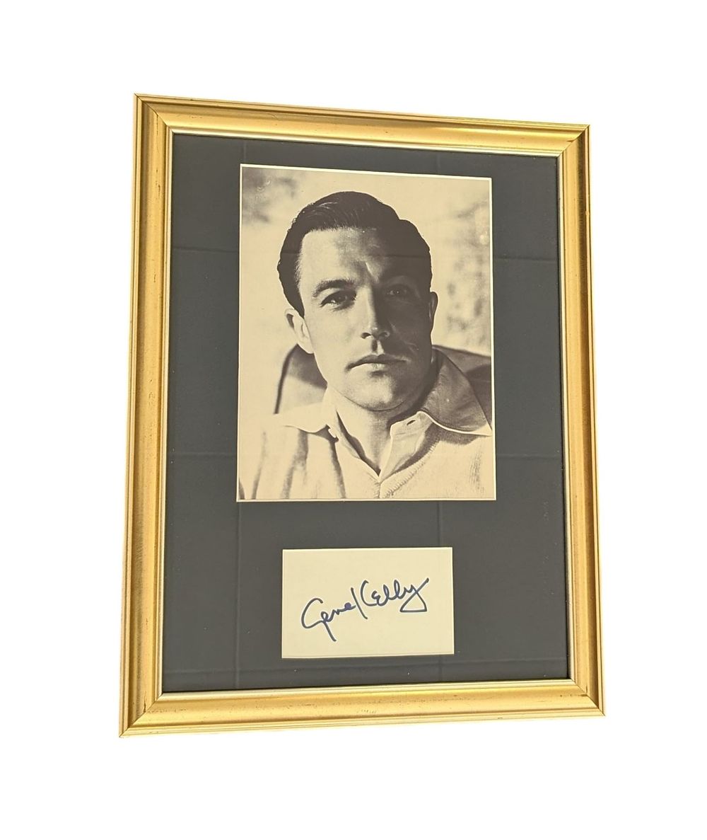 Lot 545: Gene Kelly mounted and framed signature piece including...
