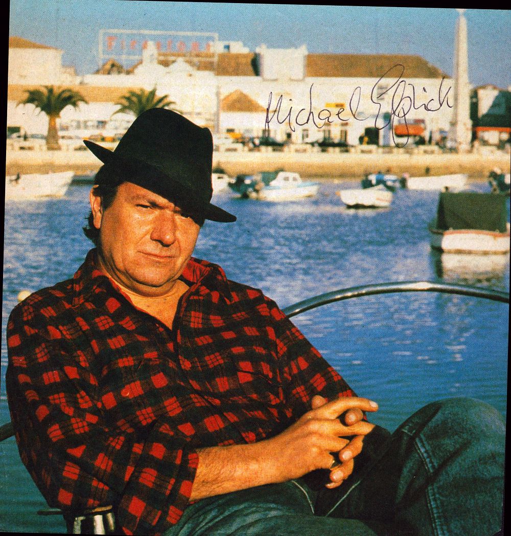 Lot 178: Michael Elphick signed 8x8inch colour magazine photo.