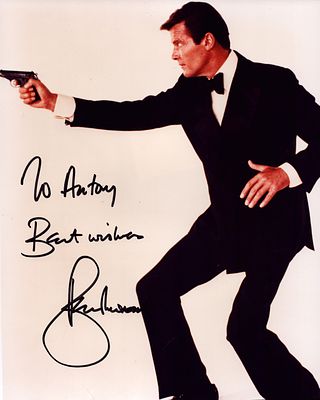 Roger Moore signed 1ox8inch colour photo. Dedicated.
