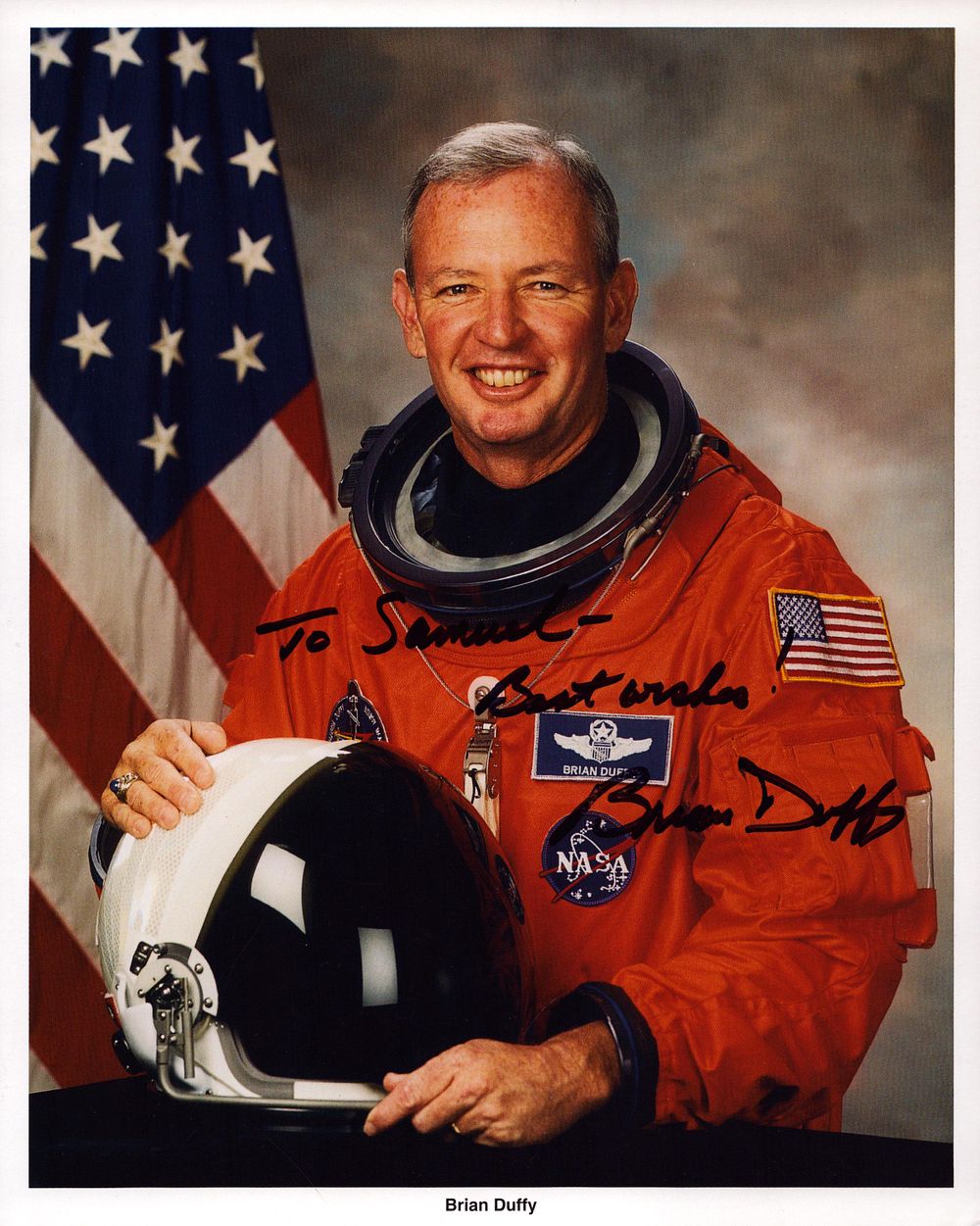Lot 172: Brian Duffy signed NASA spacesuit photo size 10X8...