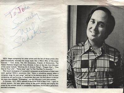Neil Sedaka Signed 10X8 inch black and white newspaper page. Dedicated