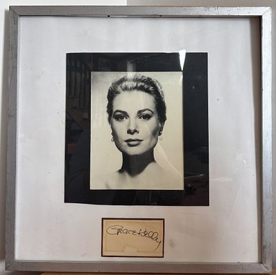 Grace Kelly signed card mounted with black and white photo. Framed 21x21.