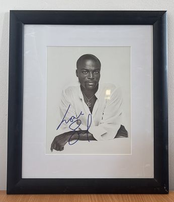 Seal signed black and white framed photo. 14x16.