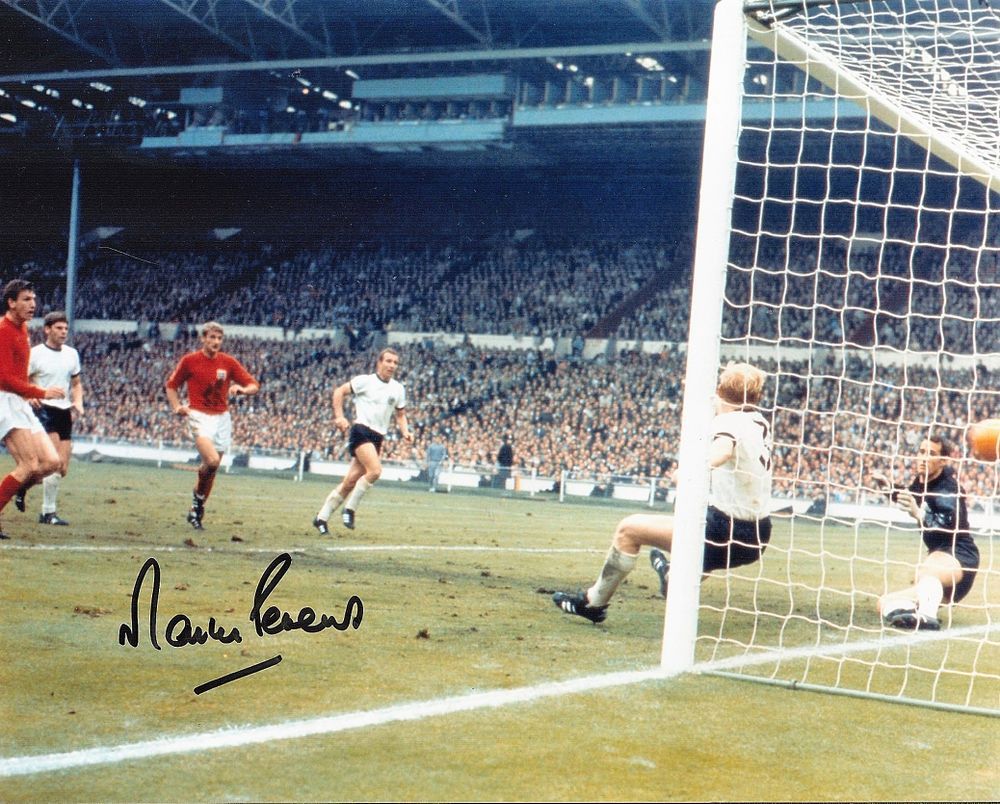 Football. Martin Peters Signed 10x8 colour photo. Photo shows the Peters watching to see if 