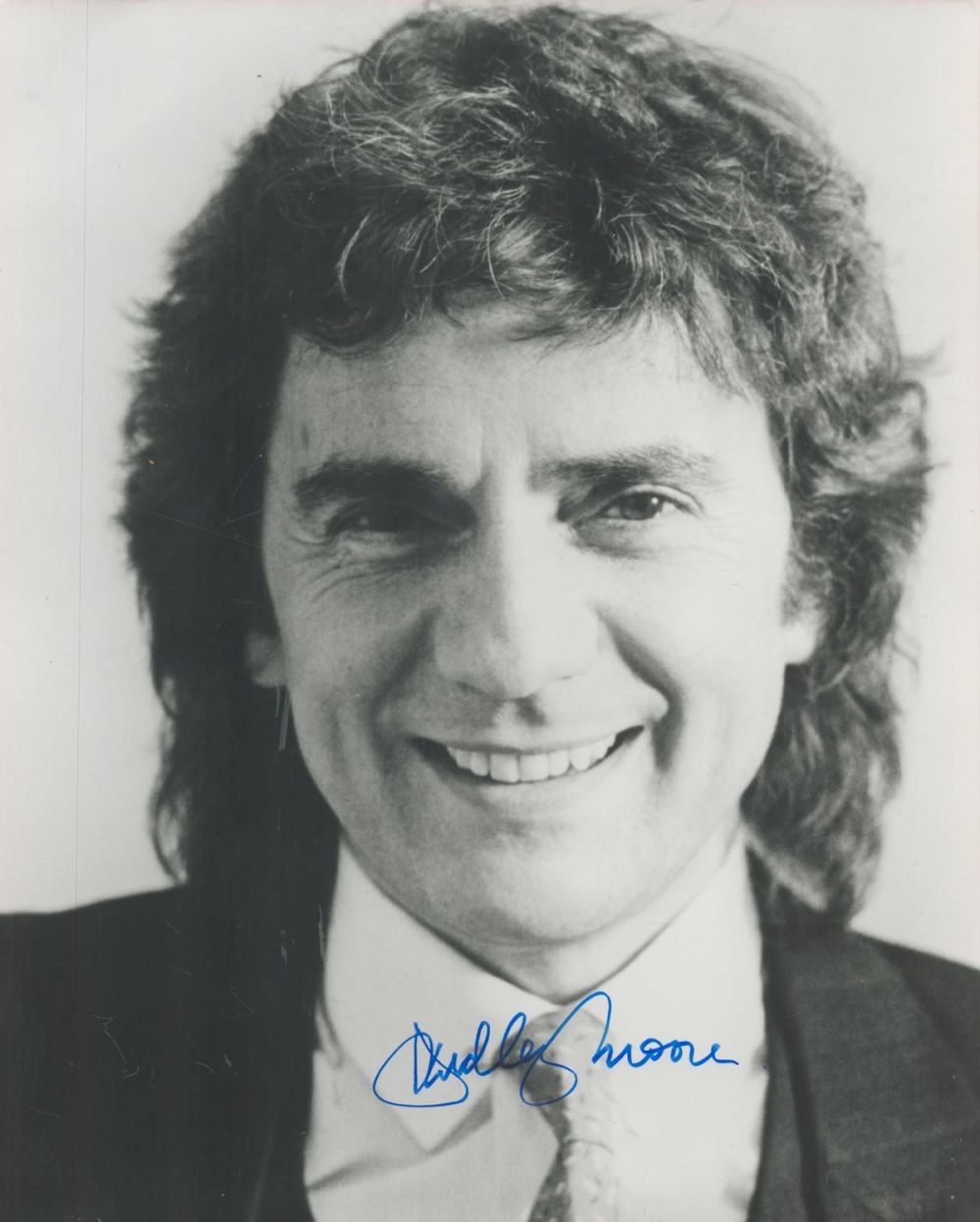 Lot 221: Dudley Moore signed 10x8 black and white photo....