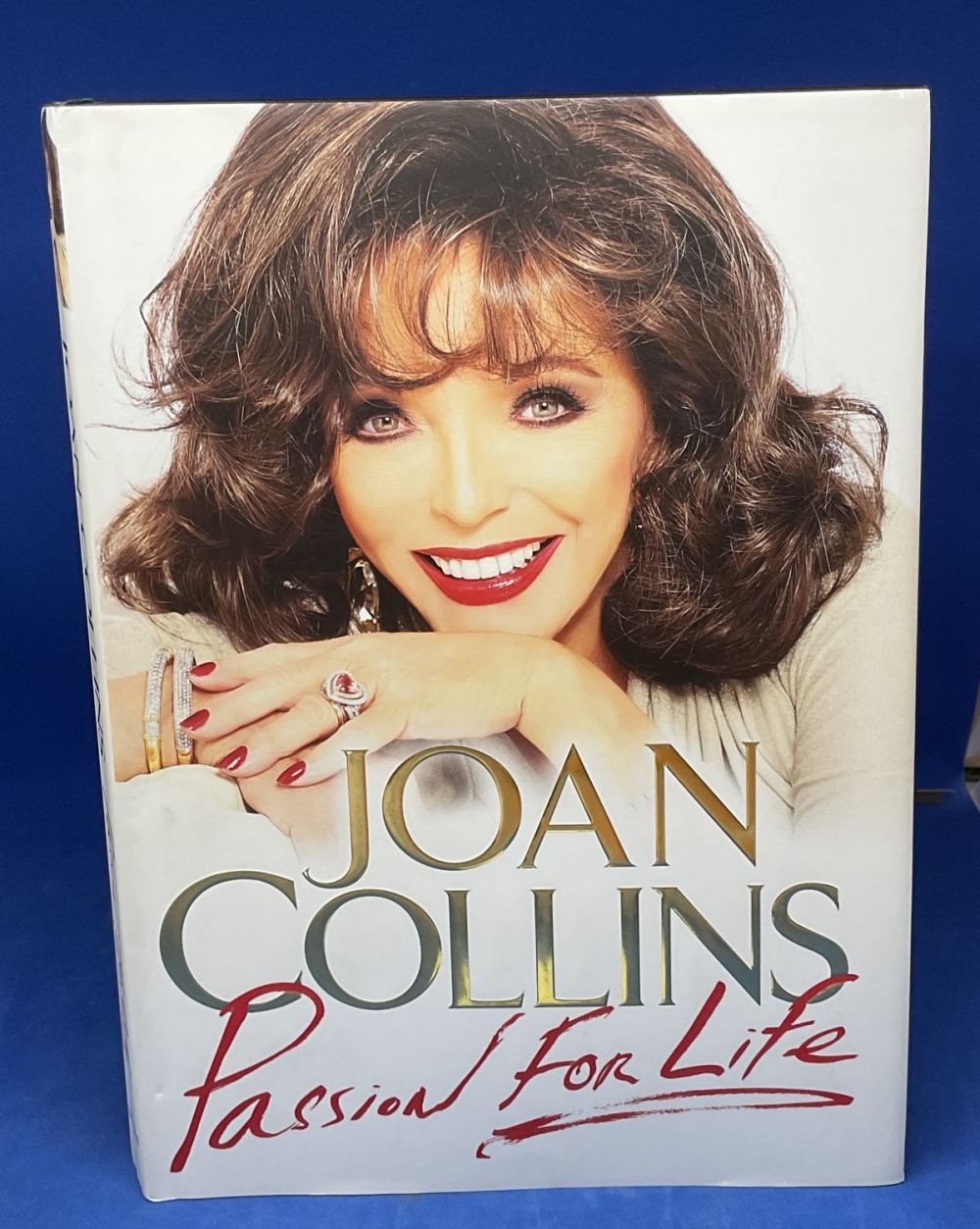 Lot 158: Joan Collins signed hardback book titled Passion for...
