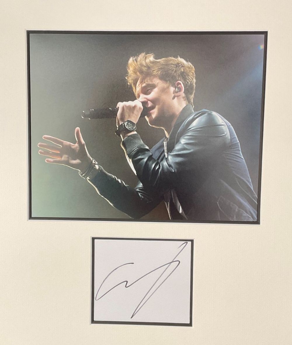 Lot 539: Conor Maynard signature piece autograph presentation. Mounted with unsigned photo to approx. 16 x 12