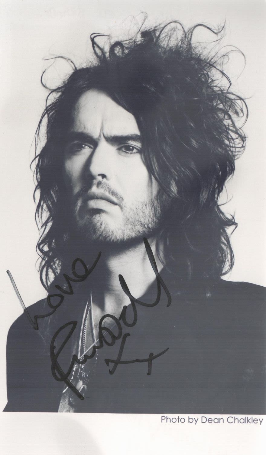Lot 199: Russell Brand signed 7x4 black and white photo....