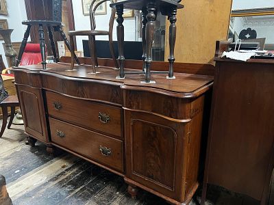 Victorian mahogany sideboard, . It features a serpentine breakfront shape with moulded arched 