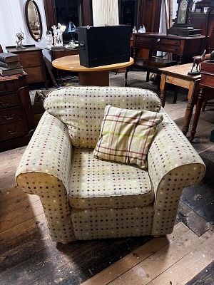 Two Fabric Armchairs. fabric-upholstered armchair featuring a light-colored base with 