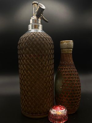 Pair of antique barware items. A large soda syphon with mesh covering and a matching smaller 