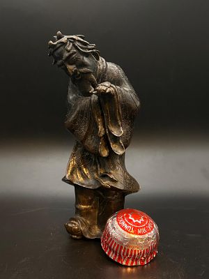 Bronze sculpture depicting a Chinese Daoist figure. Possibly Shou Lao or another immortal, often 