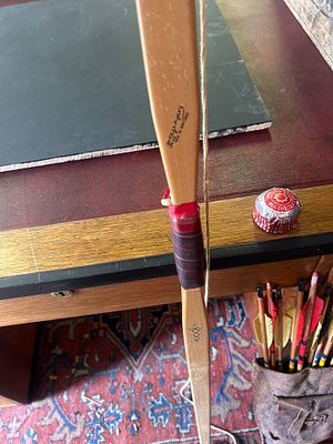 vintage longbow and a set of arrows, . Longbow: A traditional, straight-limbed bow, often 