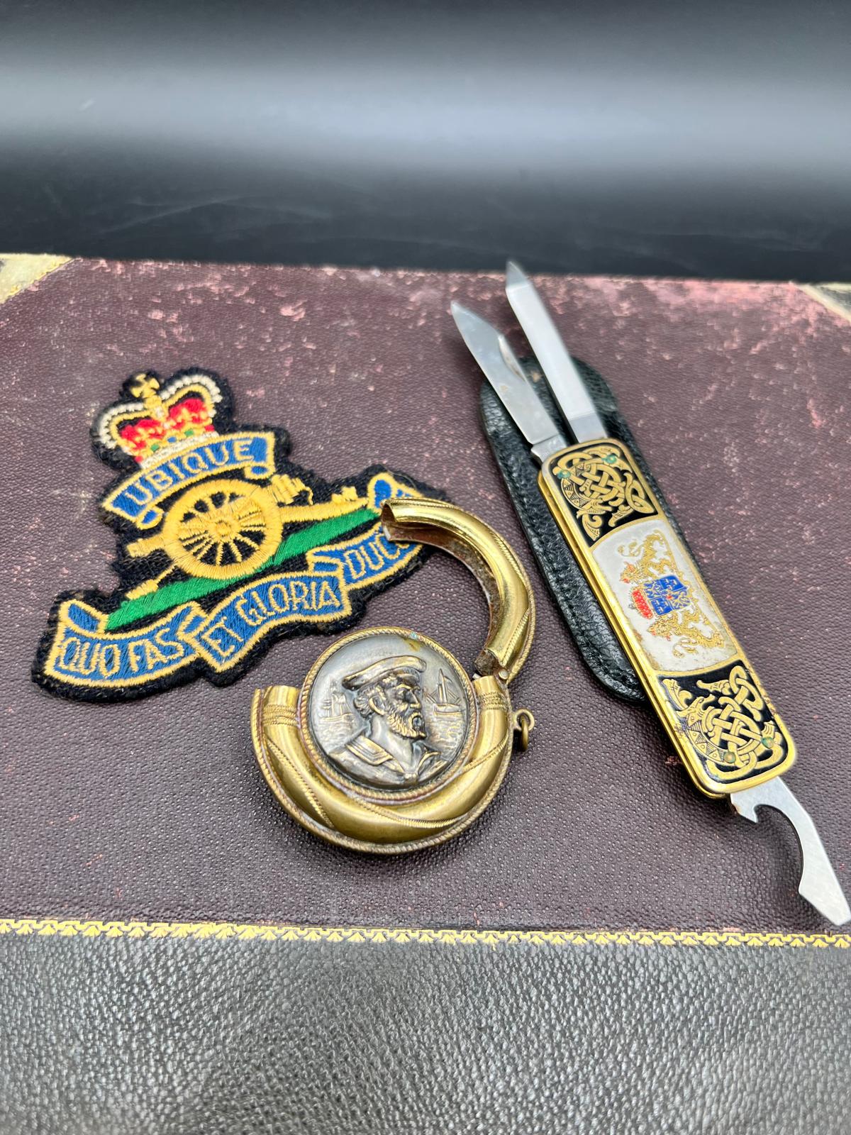 A Trio of Collectibles Including a Royal Artillery Bullion Blazer Badge and a Damascene Style Multi-tool