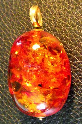 A 34mm high Large Baltic Honey Amber Cabochon Pendant suspended on 18ct gold with a slim gold 