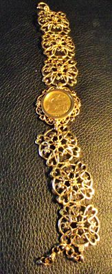 Vintage Ladies 9ct 375 open work bracelet marked on each link set with a 22ct 1901 half 