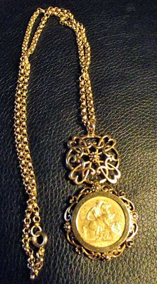 Ladies 9ct gold open work pendant on 9ct gold chain with 1909 full sovereign 27g approx . A 