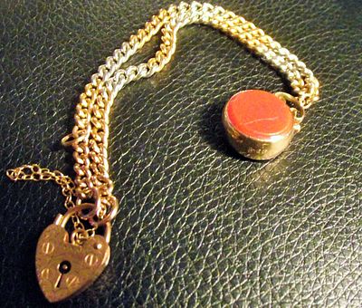 Vintage 9ct gold padlock bracelet with fully marked 9ct gold red green fob 18.27g approx . Vintag 