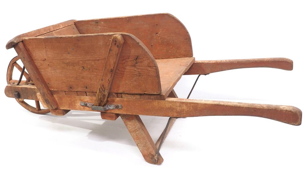 Lot 190: Early wooden, child-size primitive wheelbarrow with some red paint, 43"L overall