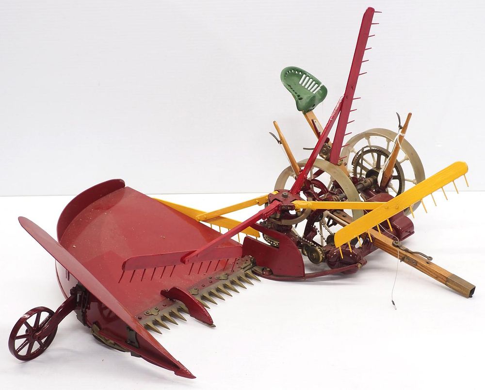 Lot 242: Large salesman sample reaper with brass wheels, approx. 24"W x 24"L, makers tag for C.M. Clinton, Model Maker, Ithaca NY