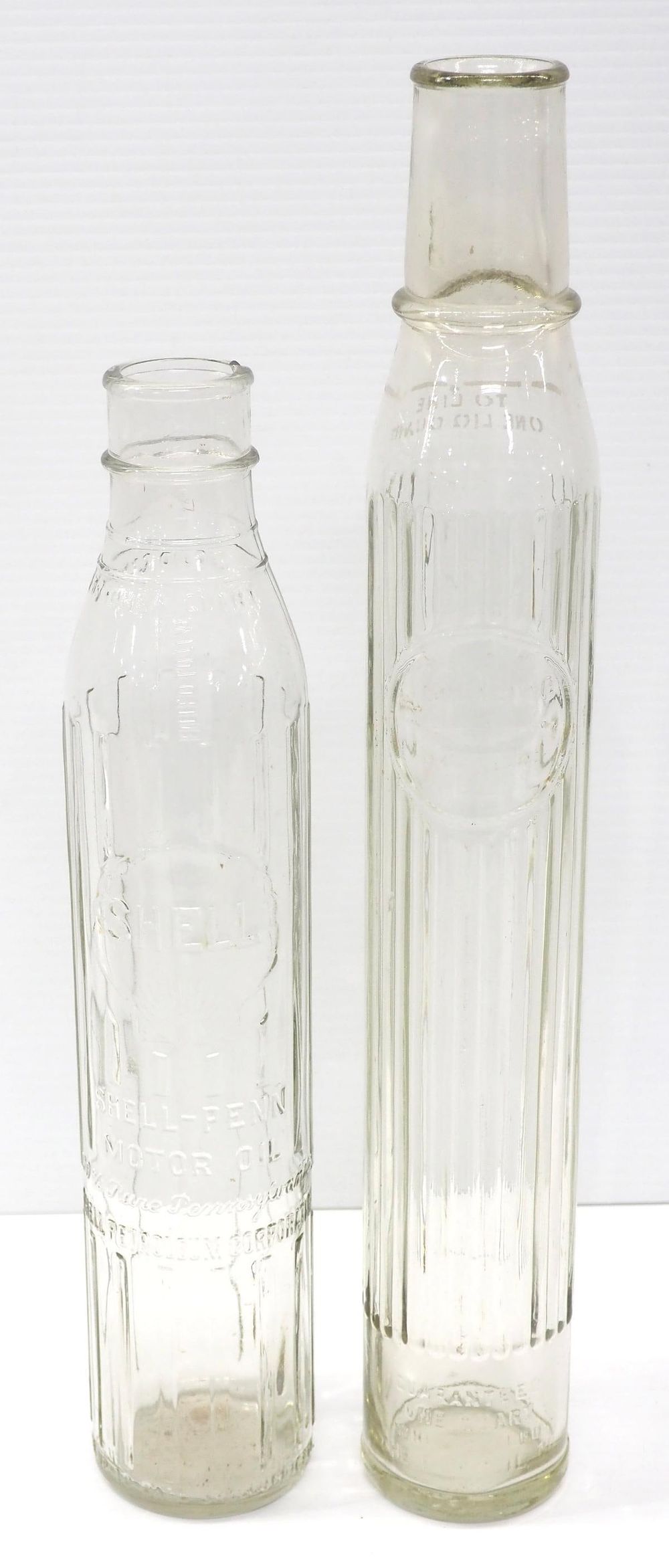 Lot 274: (2) 1-quart tall glass oil bottles with labels