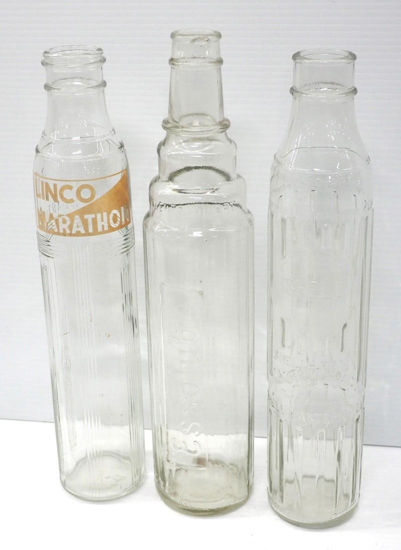 Lot 324: (3) 1-quart tall glass oil bottles