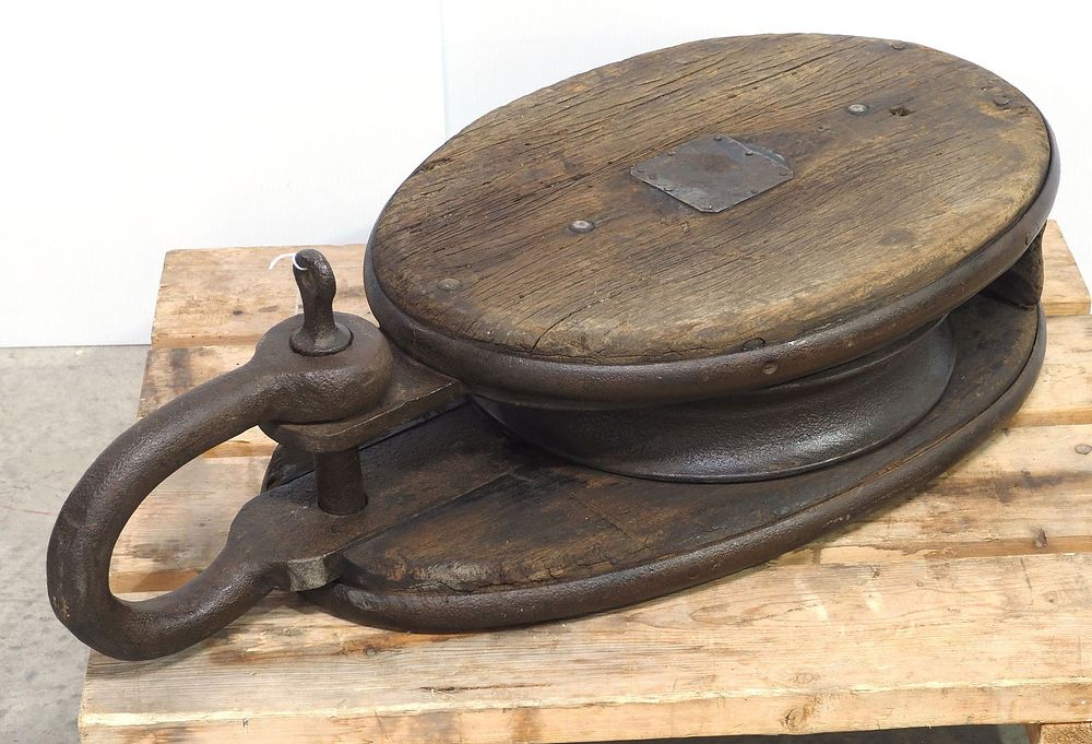 Lot 785A: Oversized cast iron and wood pulley