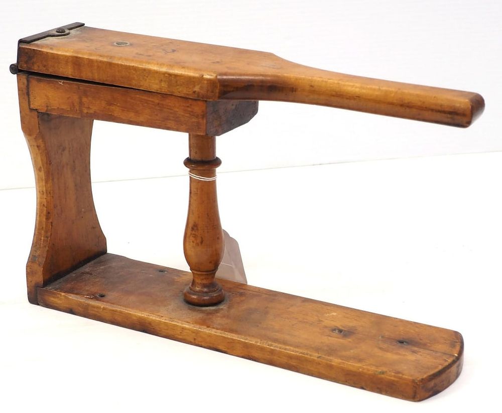 Lot 167: Early wooden table-top lemon squeezer