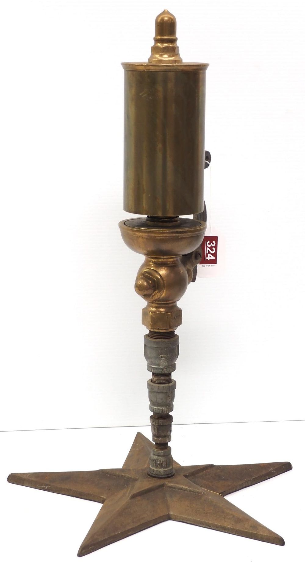 Lot 324: Brass steam whistle on cast iron star base