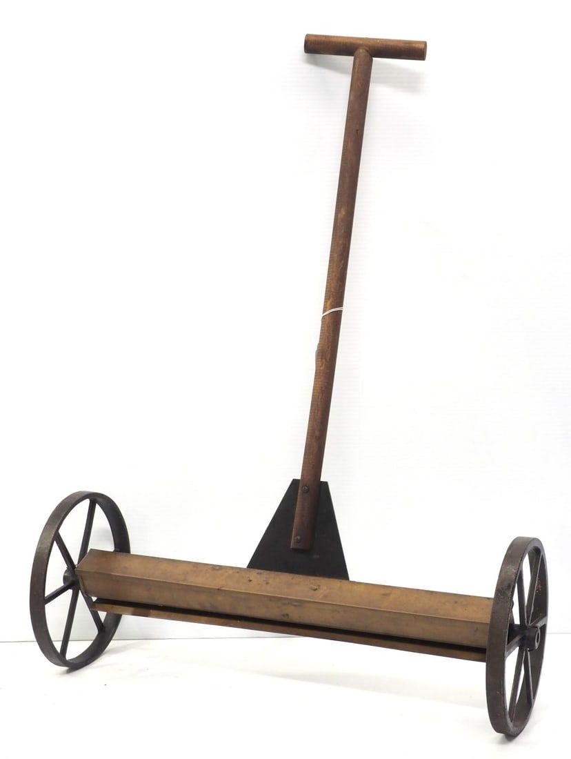 Lot 679: Brass lawn seeder with cast iron wheels